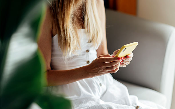 Illustrative art shows a woman using her cell phone, referring to app store optimization.