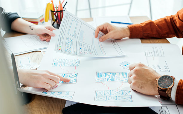 Illustrative art shows a team studying the app design.