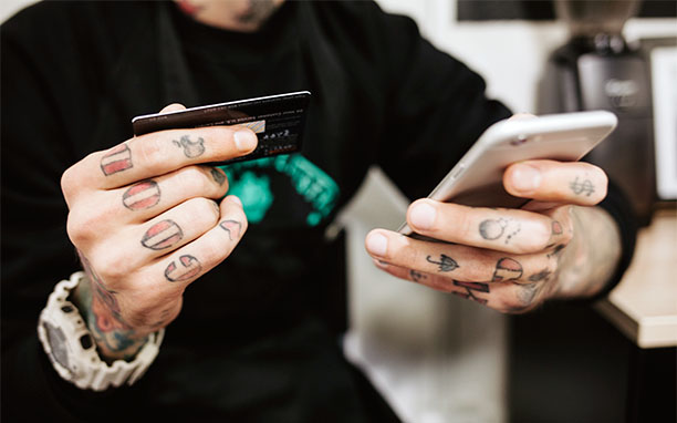 Man using cell phone to search what is m commerce.